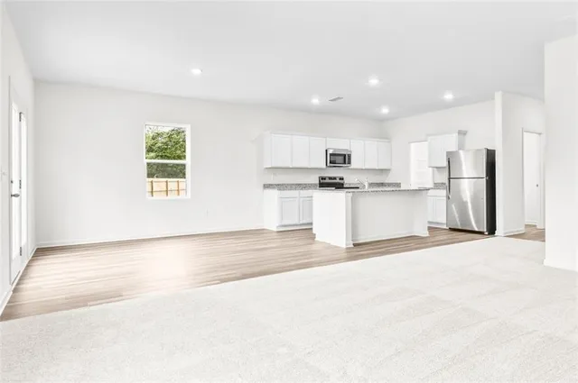 a view of a kitchen with a sink a window and stainless steel appliances