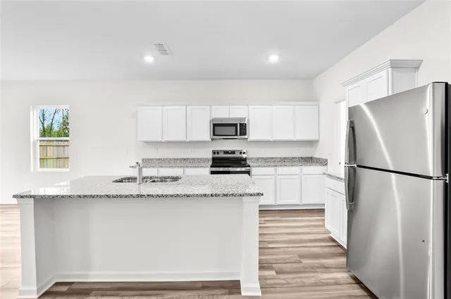 a kitchen with granite countertop cabinets and refrigerator