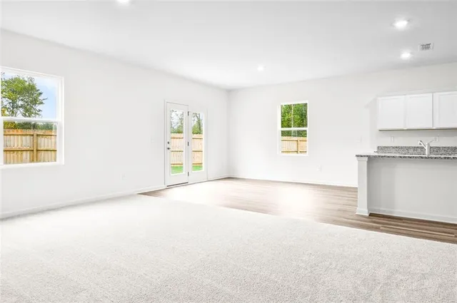 an empty room with windows and closet