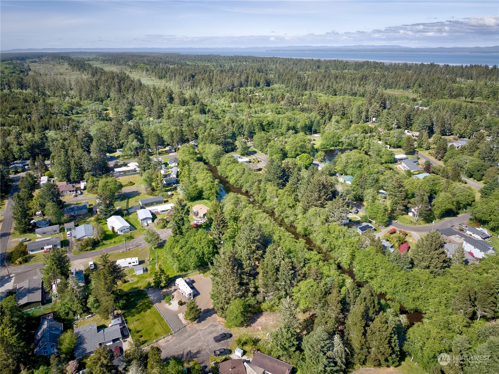 1413 321st Place Ocean Park, WA 98640 - Photo 12 of 20 a view of a city with lush green forest
