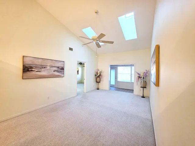 a view of a livingroom with a ceiling fan and window