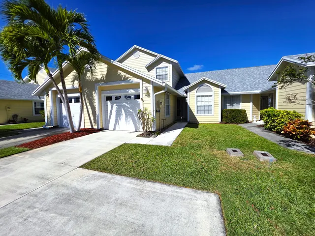 a front view of a house with a yard and porch