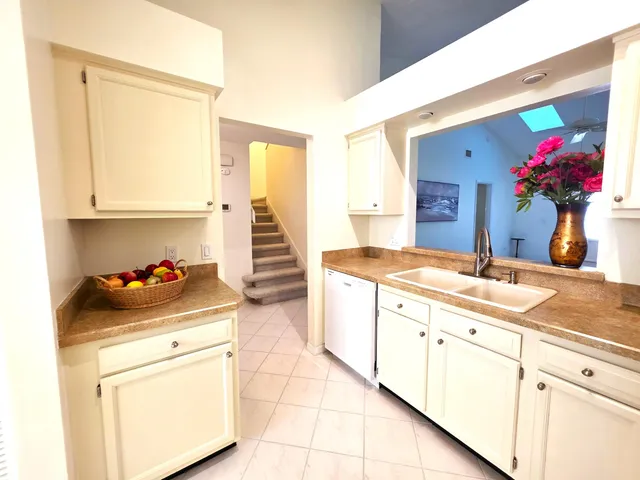 a kitchen with a sink cabinets and a stove