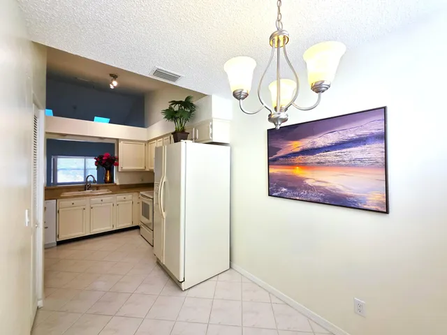 a kitchen with stainless steel appliances a refrigerator and microwave