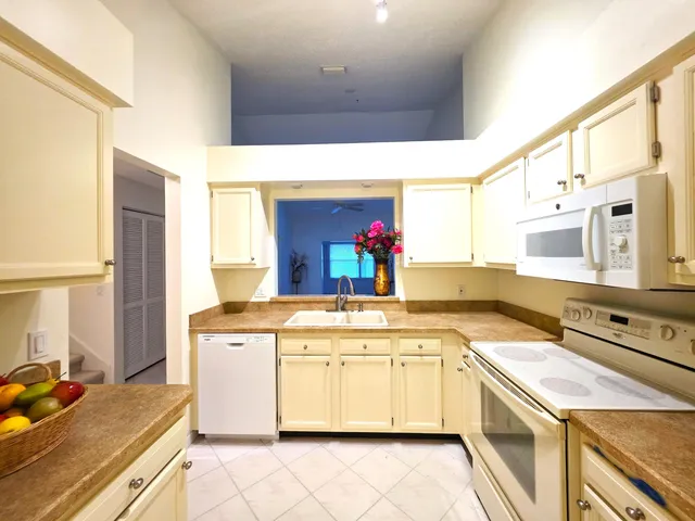 a kitchen with a stove sink and cabinets