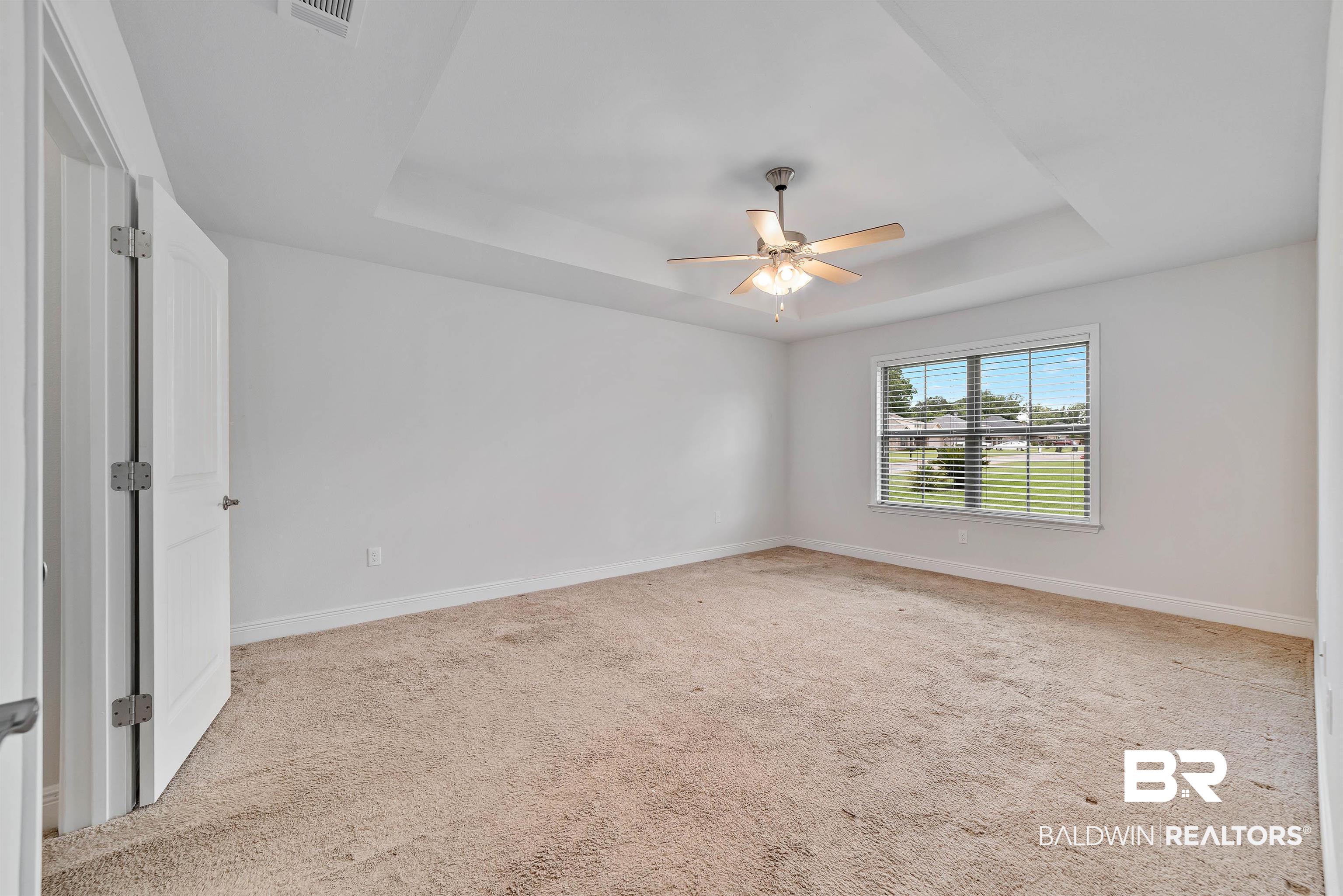 13155 Wishbone Court Foley, AL 36535 - Photo 20 of 39 Spare room featuring a raised ceiling, light colored carpet, and ceiling fan