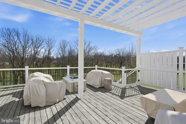 a roof deck with couches and wooden floor