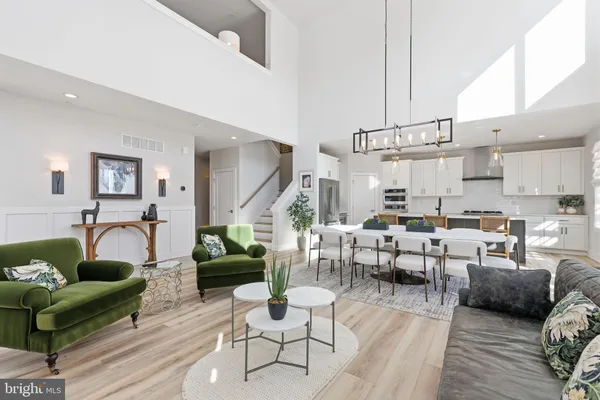 a living room with lots of furniture and view of kitchen