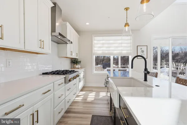 a kitchen with granite countertop a stove and a sink