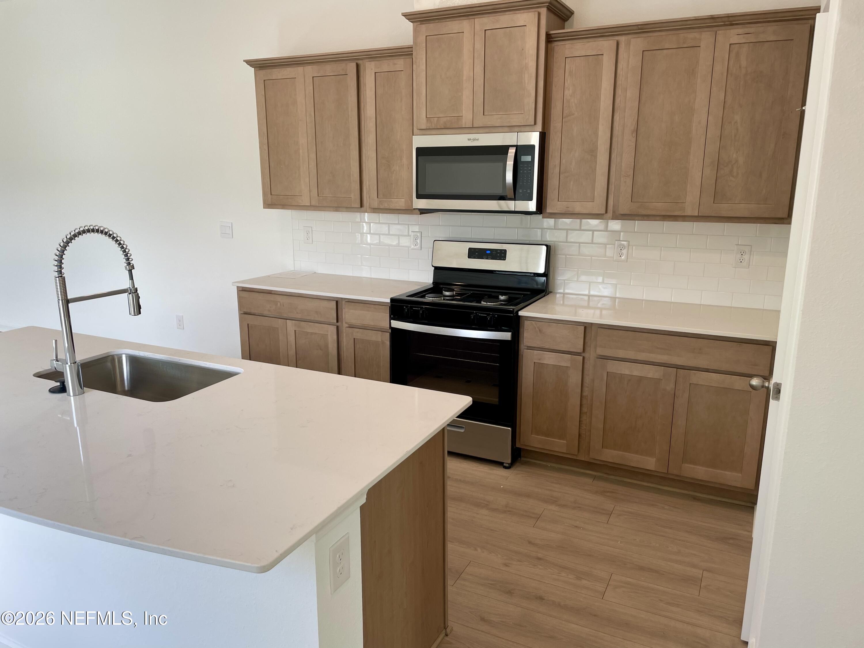 3 Divot Place Bunnell, FL 32110 - Photo 11 of 63 a kitchen with a sink a stove and microwave