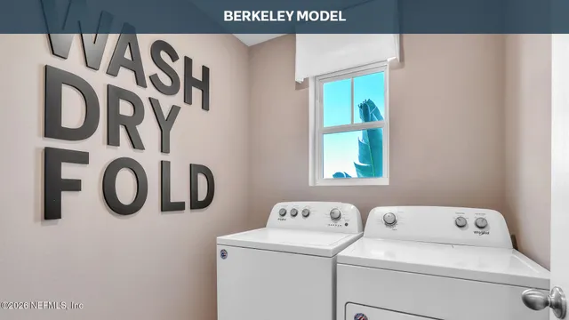 a kitchen with stainless steel appliances a sink a stove a refrigerator cabinets and wooden floor