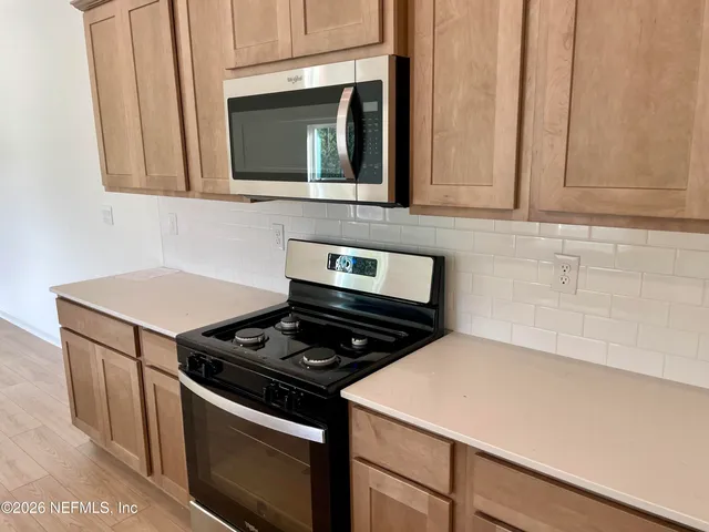 a living room with furniture and a flat screen tv with wooden floor