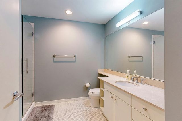 a bathroom with a sink a toilet and shower