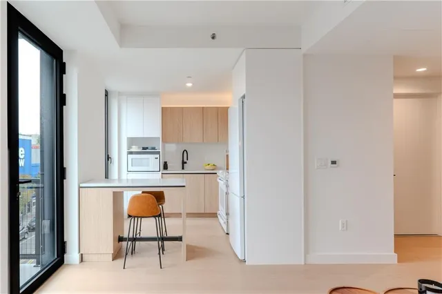 a kitchen with a refrigerator and table chair