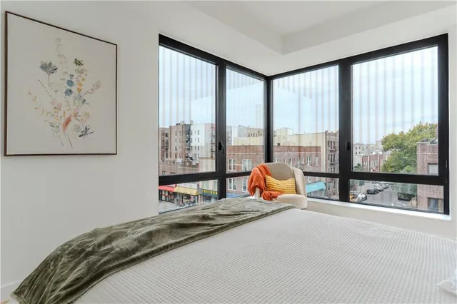 a bedroom with furniture and large window