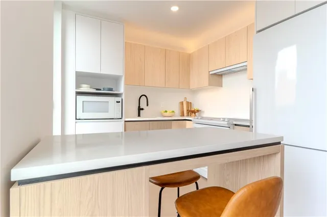 a kitchen with a sink a stove and a microwave