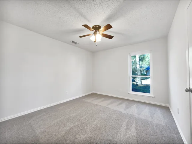 a view of an empty room with a window