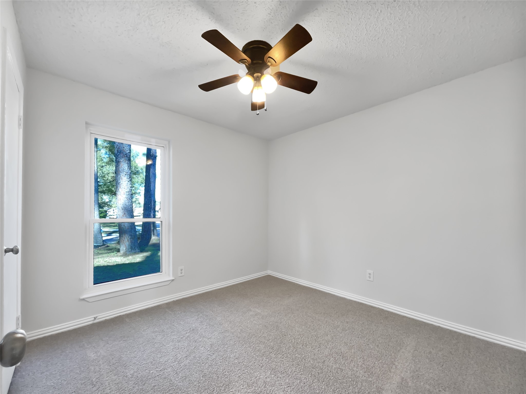 5414 Honeybear Lane Spring, TX 77373 - Photo 12 of 16 an empty room with window and ceiling fan