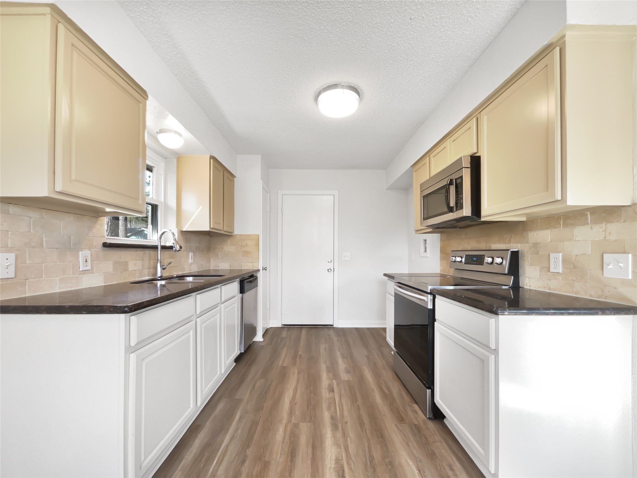 5414 Honeybear Lane Spring, TX 77373 - Photo 2 of 16 a kitchen with stainless steel appliances granite countertop wooden cabinets a stove top oven a sink and dishwasher