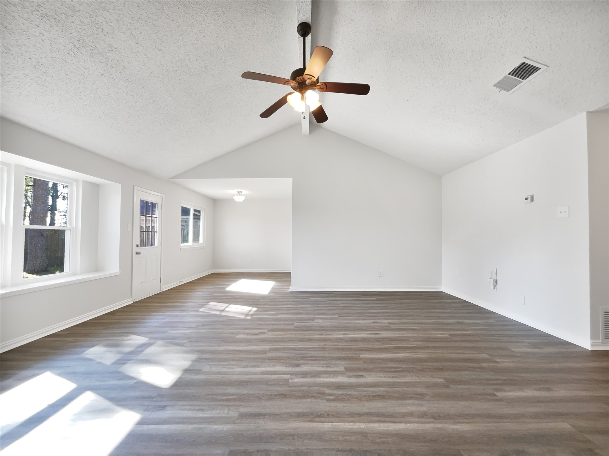 5414 Honeybear Lane Spring, TX 77373 - Photo 7 of 16 a view of an empty room with a window and wooden floor