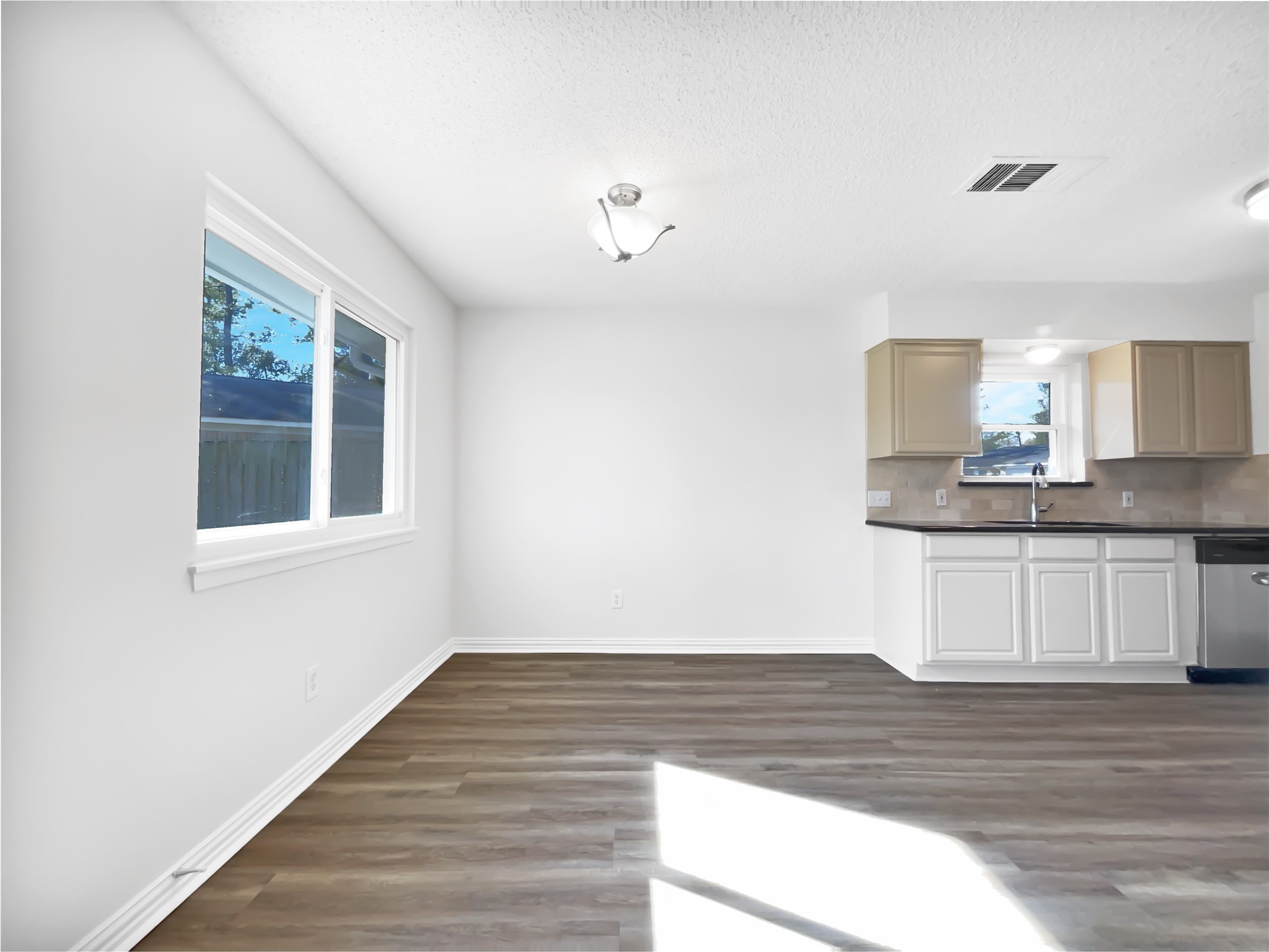5414 Honeybear Lane Spring, TX 77373 - Photo 8 of 16 a view of an empty room with wooden floor and a window