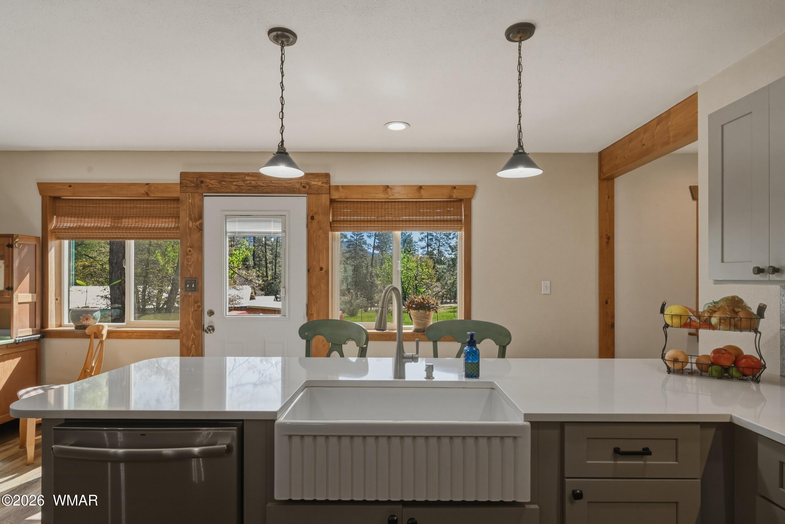 3533 Foothill Road Pine, AZ 85544 - Photo 13 of 52 a dining table with chairs a large window and a wooden floor