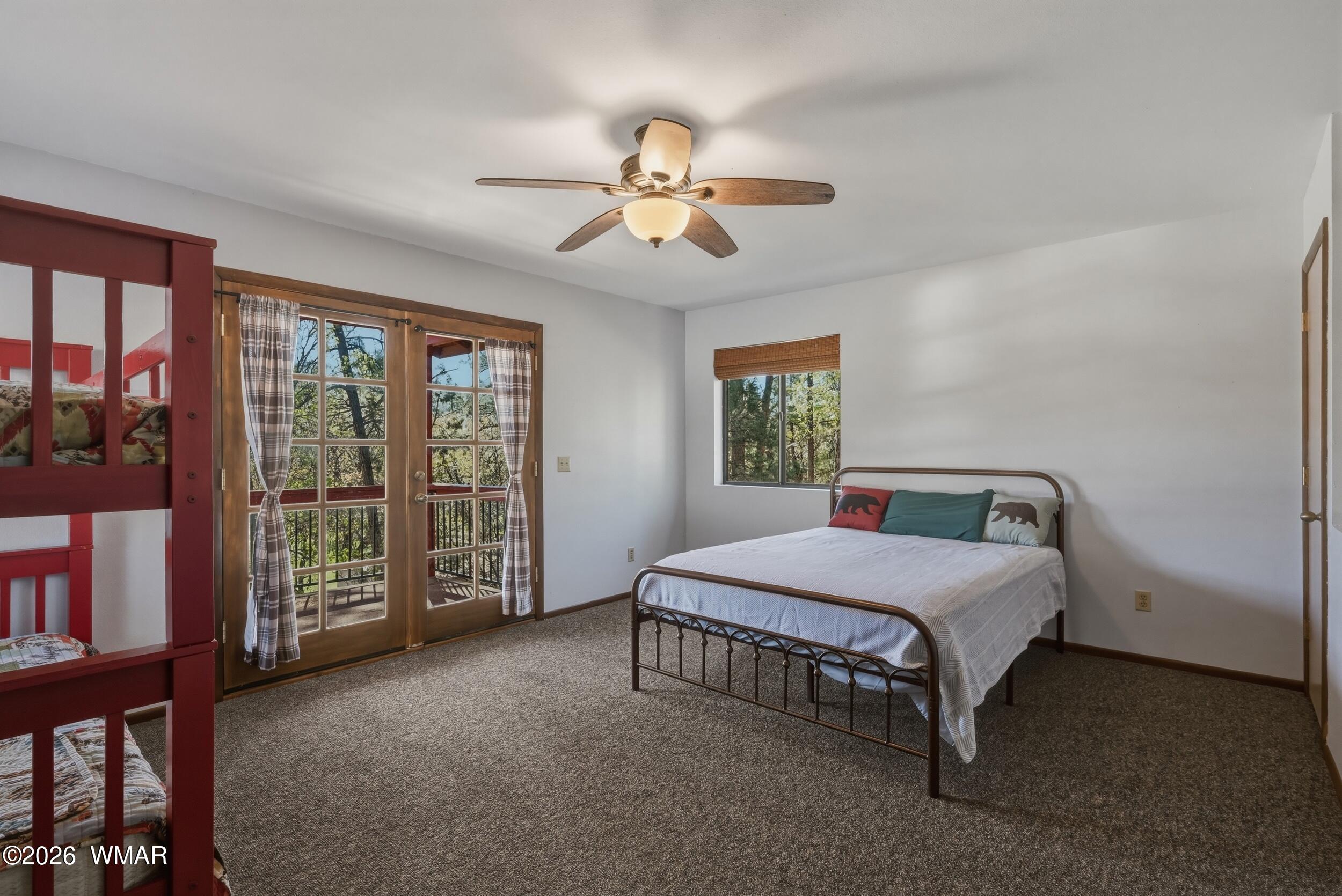 3533 Foothill Road Pine, AZ 85544 - Photo 23 of 52 a bedroom with a bed and a chandelier