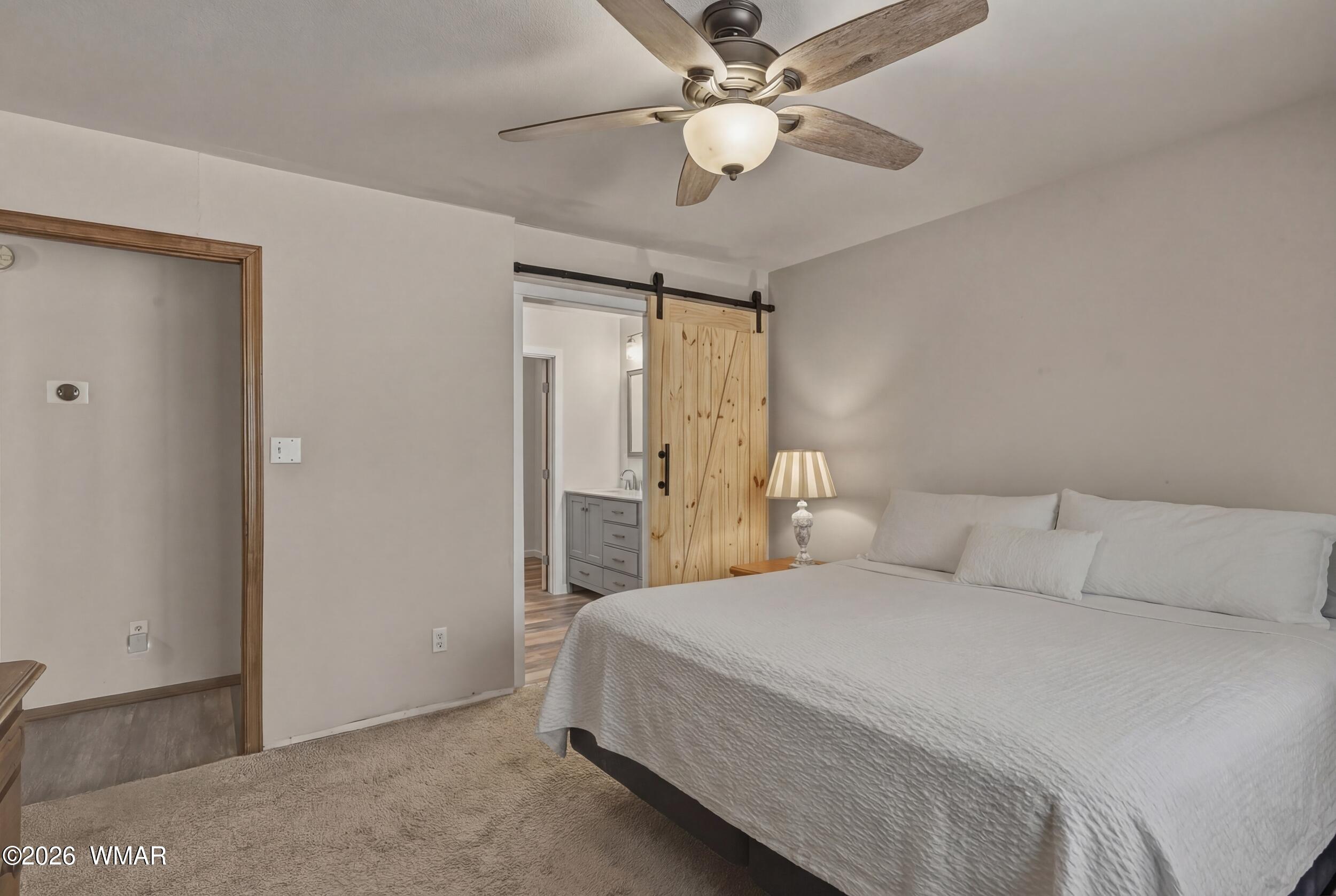 3533 Foothill Road Pine, AZ 85544 - Photo 28 of 52 a bedroom with a large bed and a ceiling fan