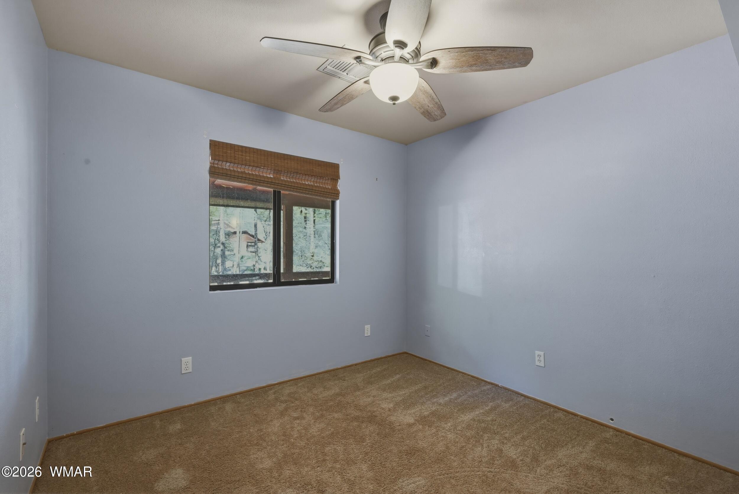 3533 Foothill Road Pine, AZ 85544 - Photo 32 of 52 an empty room with a window and a fan