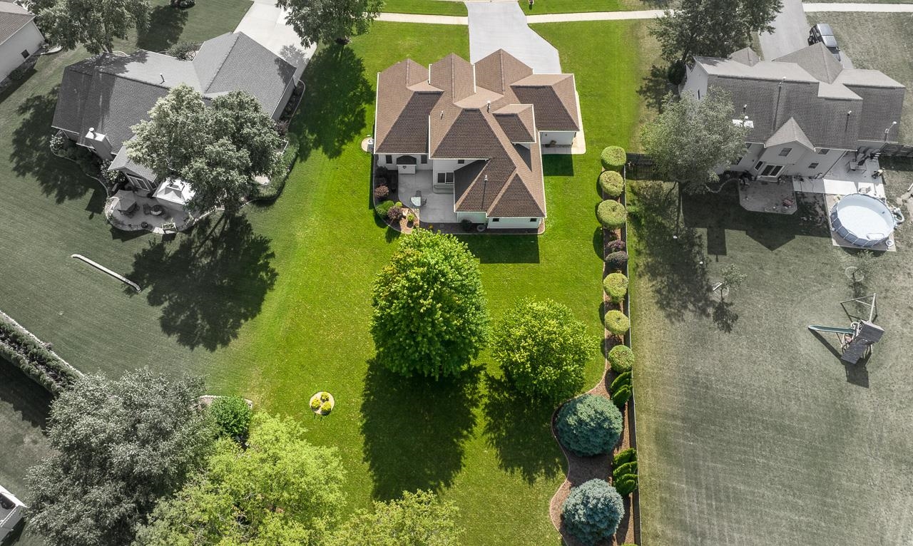 9899 Rambouillet Ridge Roscoe, IL 61073 - Photo 11 of 32 an aerial view of a house with a yard and lake view