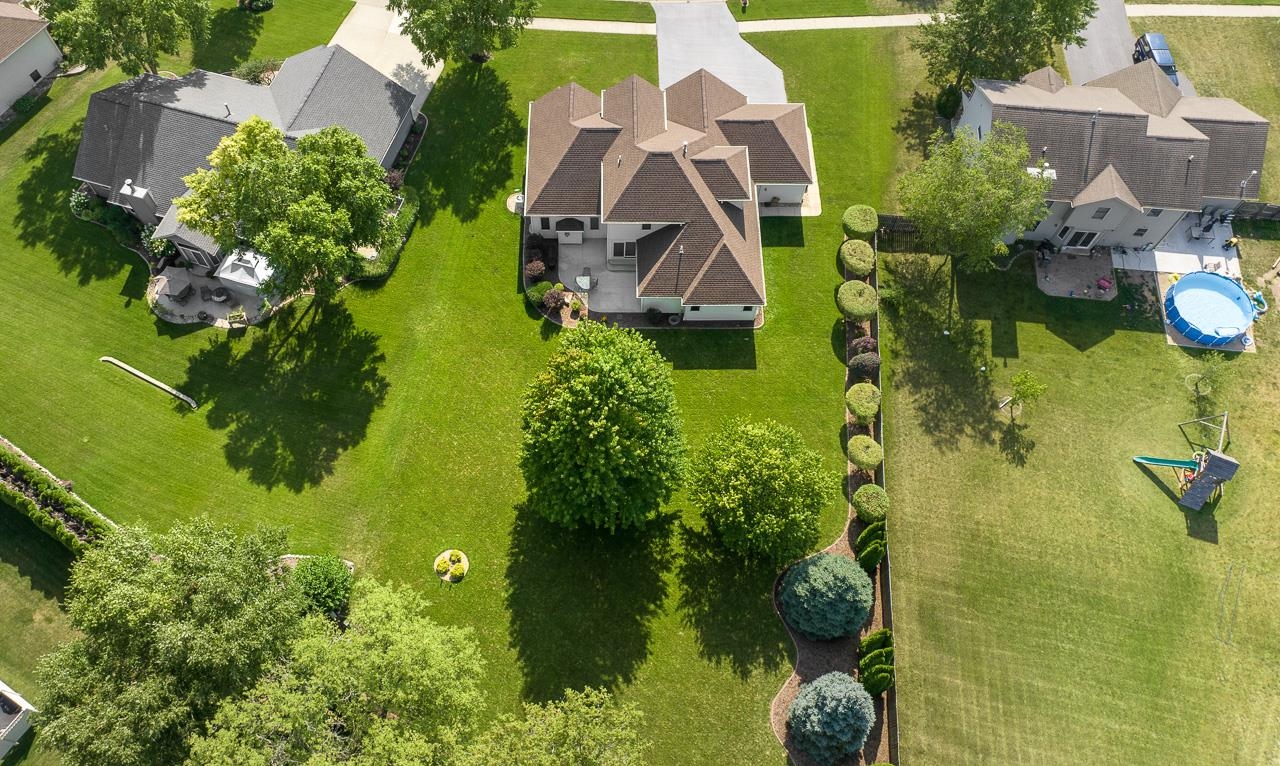 9899 Rambouillet Ridge Roscoe, IL 61073 - Photo 12 of 32 an aerial view of residential house with swimming pool and garden space