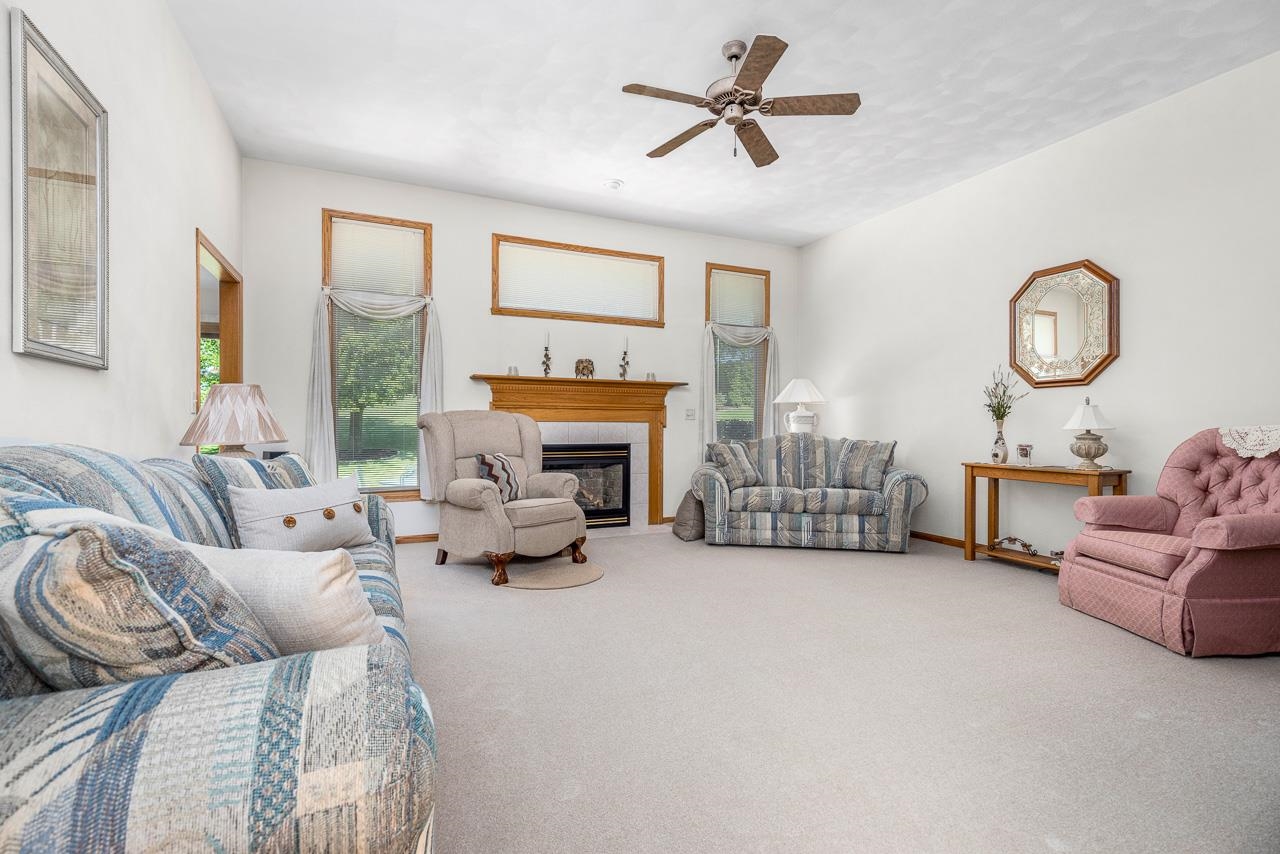 9899 Rambouillet Ridge Roscoe, IL 61073 - Photo 13 of 32 a living room with furniture large window and a fireplace