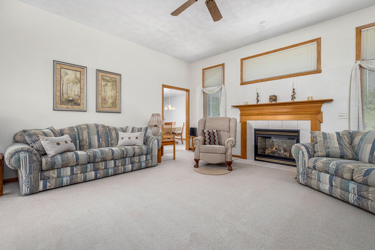 9899 Rambouillet Ridge Roscoe, IL 61073 - Photo 14 of 32 a living room with furniture and a fireplace