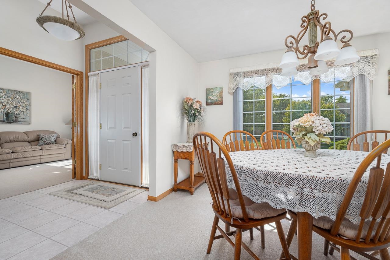 9899 Rambouillet Ridge Roscoe, IL 61073 - Photo 16 of 32 a view of a dining room with furniture window and outside view