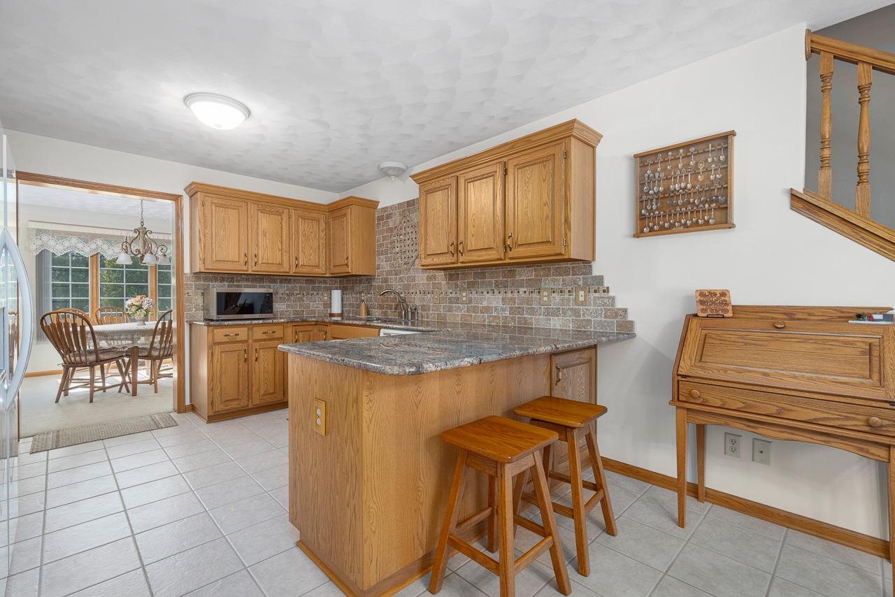 9899 Rambouillet Ridge Roscoe, IL 61073 - Photo 19 of 32 a kitchen with cabinets and chairs