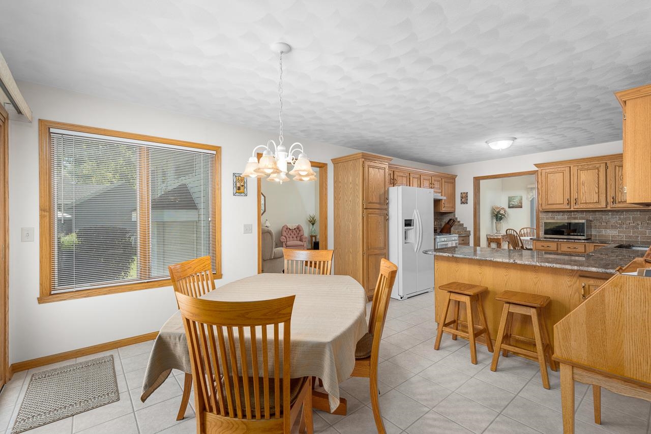 9899 Rambouillet Ridge Roscoe, IL 61073 - Photo 21 of 32 a view of a dining room with furniture window and outside view