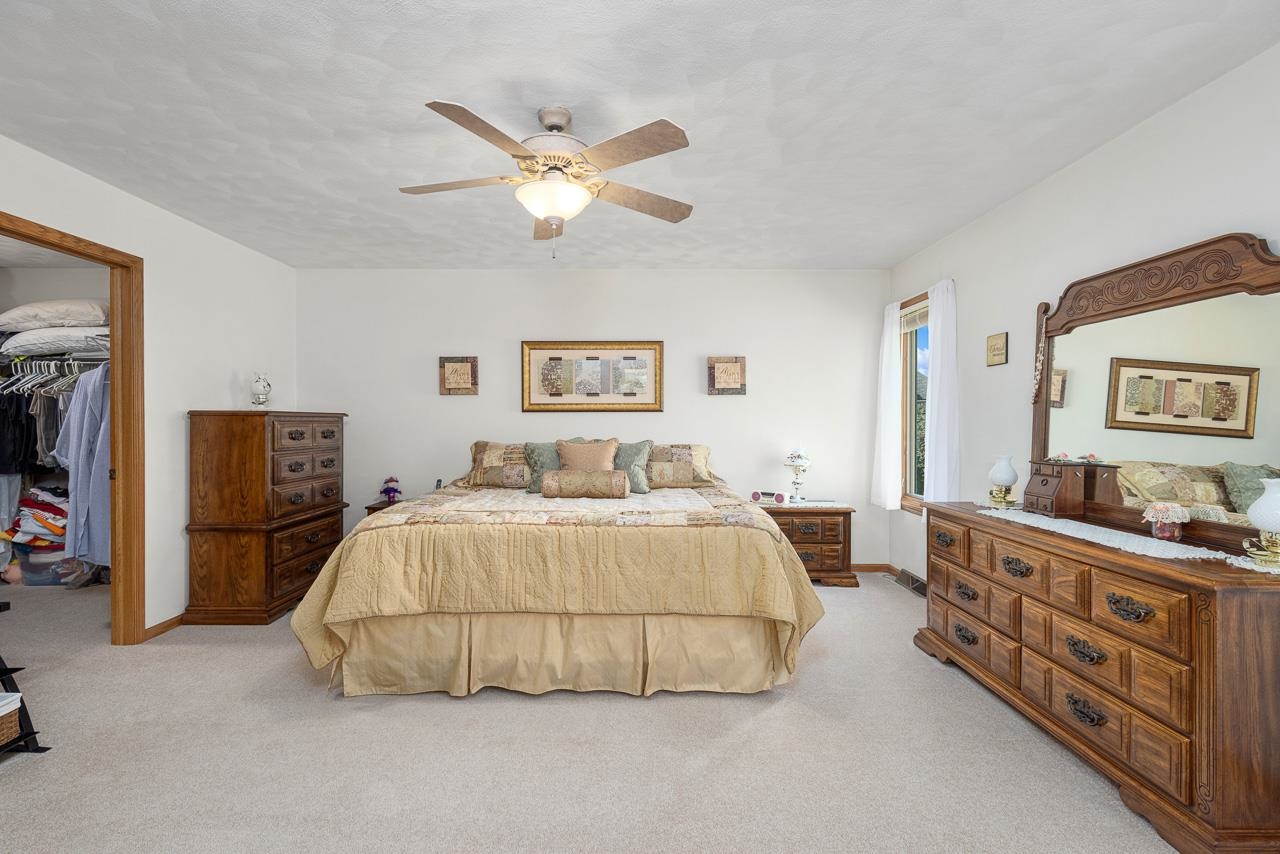 9899 Rambouillet Ridge Roscoe, IL 61073 - Photo 23 of 32 a bedroom with a bed and a dresser