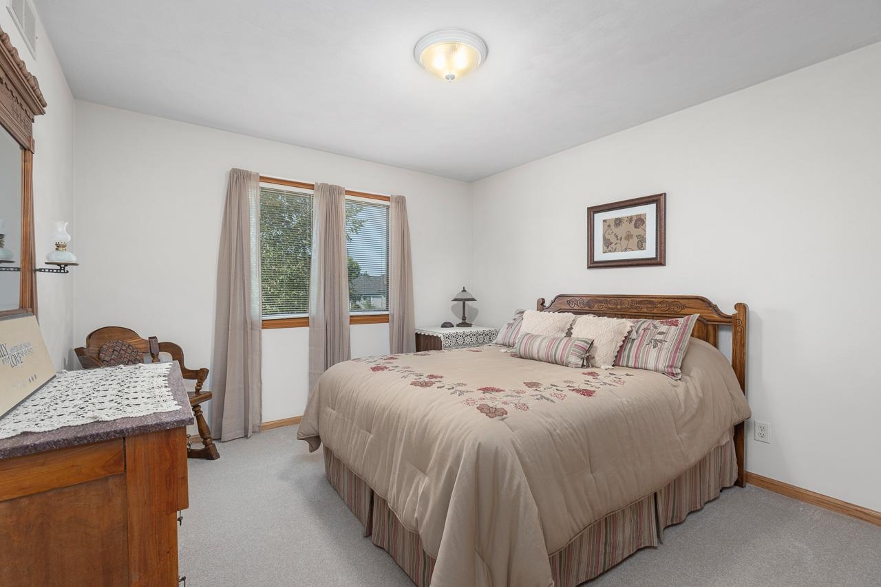 9899 Rambouillet Ridge Roscoe, IL 61073 - Photo 26 of 32 a bedroom with a bed and a window