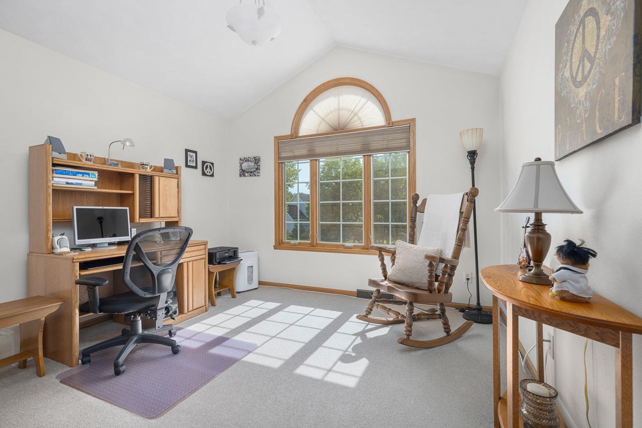 9899 Rambouillet Ridge Roscoe, IL 61073 - Photo 27 of 32 a view of a livingroom with workspace and a window