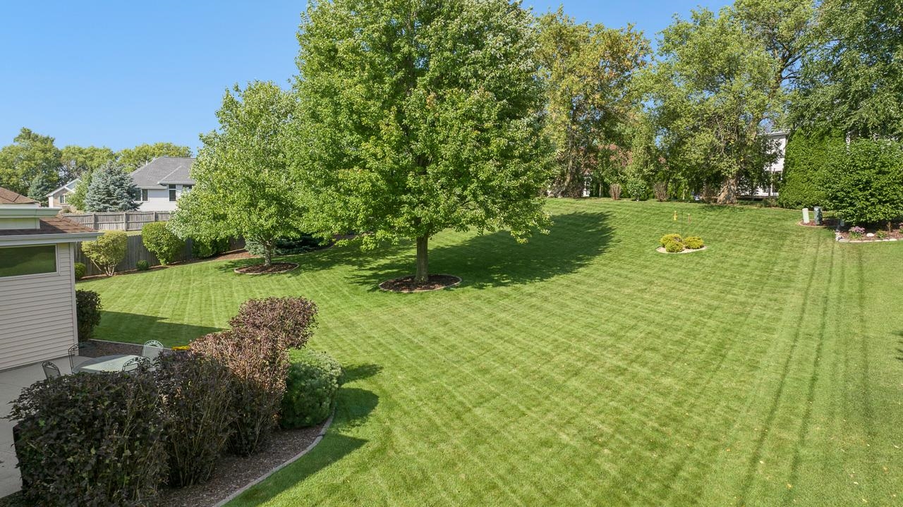 9899 Rambouillet Ridge Roscoe, IL 61073 - Photo 8 of 32 a view of a garden with a fountain