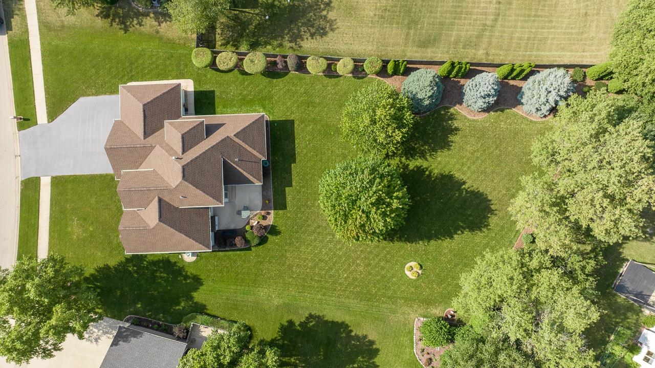 9899 Rambouillet Ridge Roscoe, IL 61073 - Photo 10 of 32 an aerial view of a house with garden space and street view