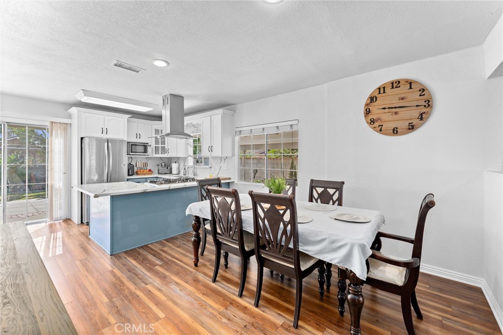 14508 Corlett Avenue Compton, CA 90220 - Photo 14 of 47 a view of a dining room with furniture a kitchen and chandelier