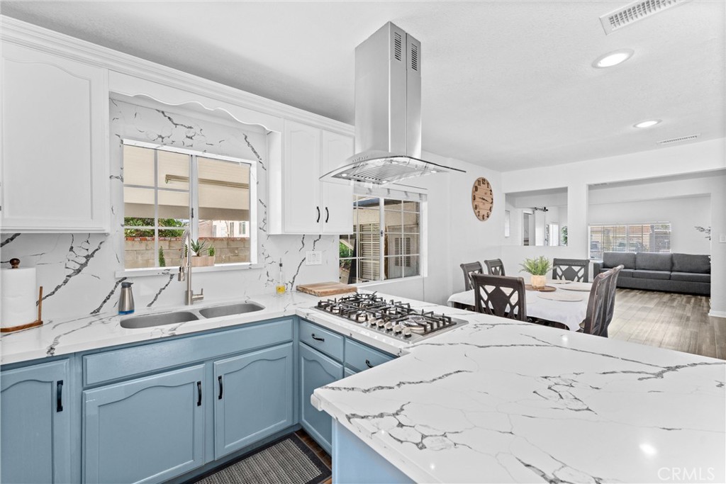 14508 Corlett Avenue Compton, CA 90220 - Photo 18 of 47 a kitchen with stainless steel appliances kitchen island granite countertop a sink stove and cabinets