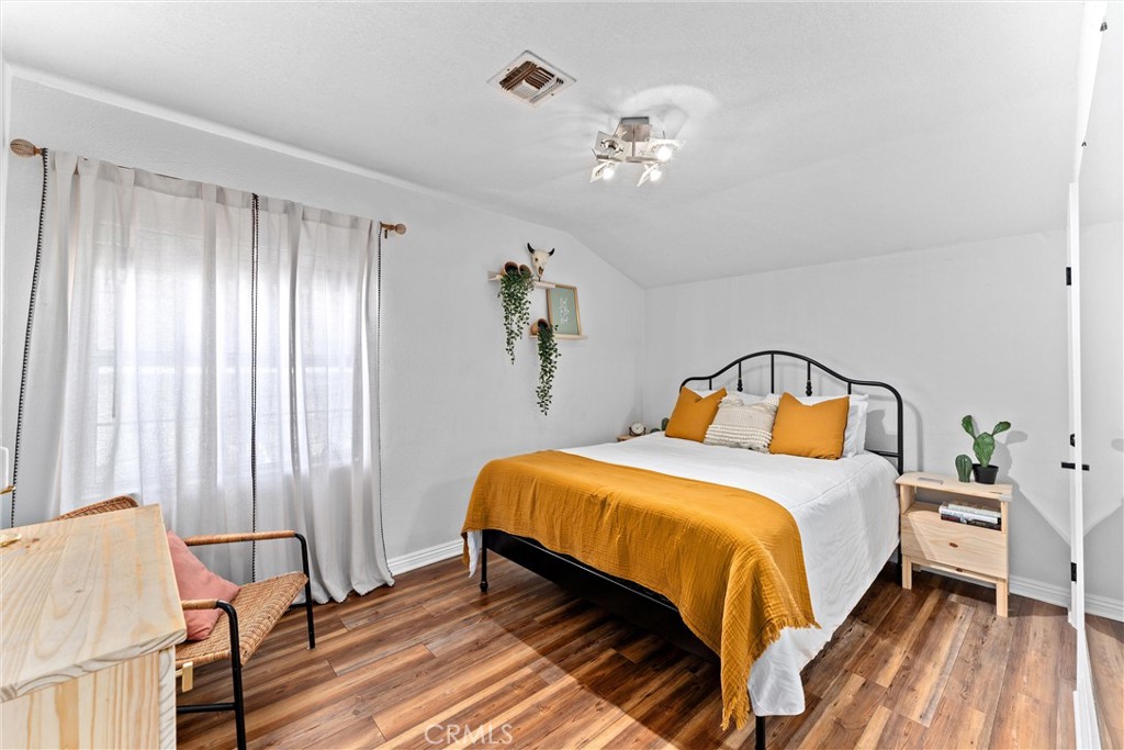 14508 Corlett Avenue Compton, CA 90220 - Photo 22 of 47 a bedroom with a bed and wooden floor