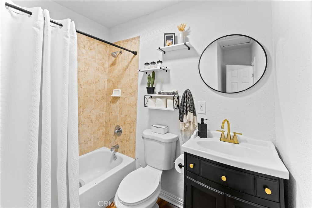 14508 Corlett Avenue Compton, CA 90220 - Photo 26 of 47 a bathroom with a sink a toilet and a mirror