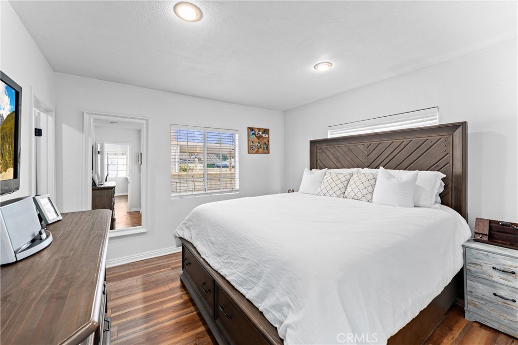 14508 Corlett Avenue Compton, CA 90220 - Photo 27 of 47 a spacious bedroom with a bed and wooden floor