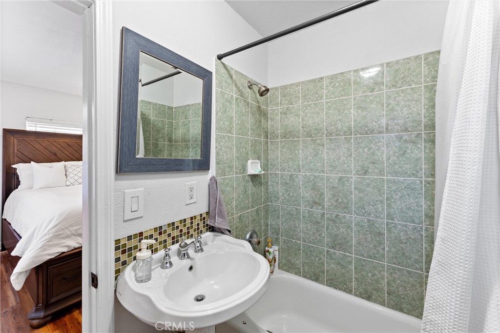 14508 Corlett Avenue Compton, CA 90220 - Photo 29 of 47 a bathroom with a sink a mirror and a shower