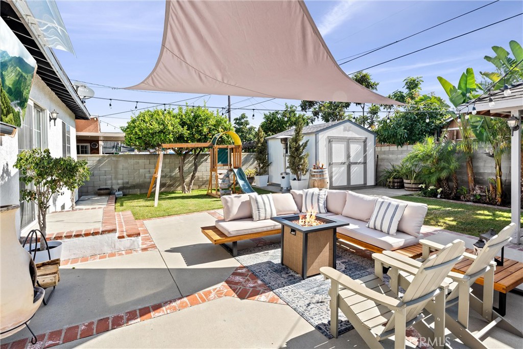14508 Corlett Avenue Compton, CA 90220 - Photo 38 of 47 a view of a patio with couches table and chairs under an umbrella