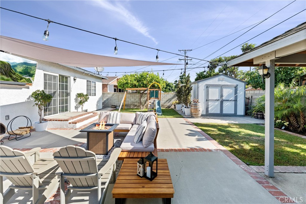 14508 Corlett Avenue Compton, CA 90220 - Photo 39 of 47 a view of a patio with table and chairs potted plants with wooden floor and floor to ceiling window