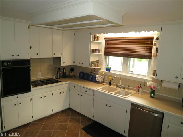 930 Redding Road Asheboro, NC 27203 - Photo 2 of 15 Kitchen. The bright kitchen offers ample counterspace, a wall oven, range top with vent, tile flooring and fresh paint.